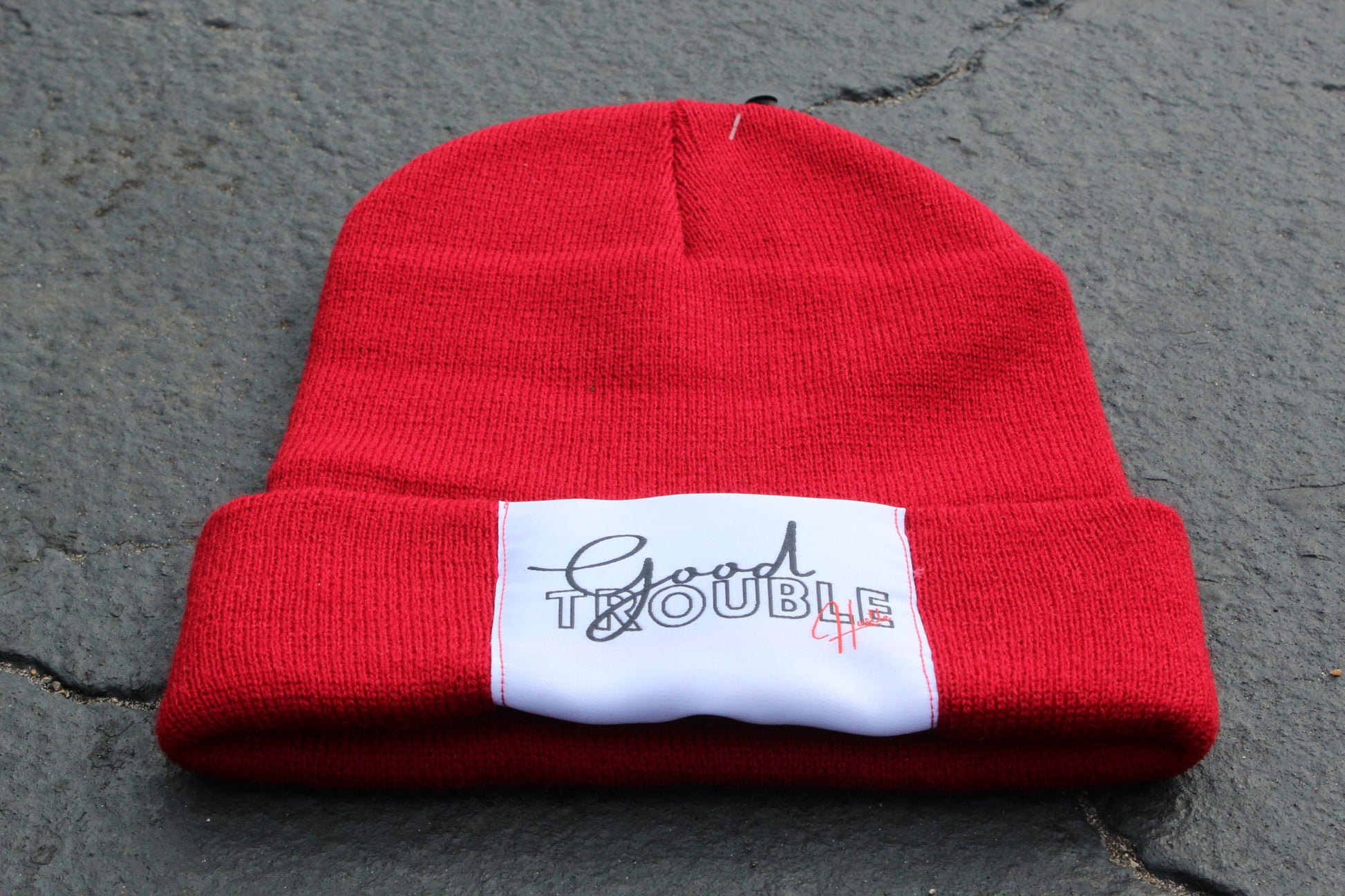 Red beanie with Good Trouble hustle Logo