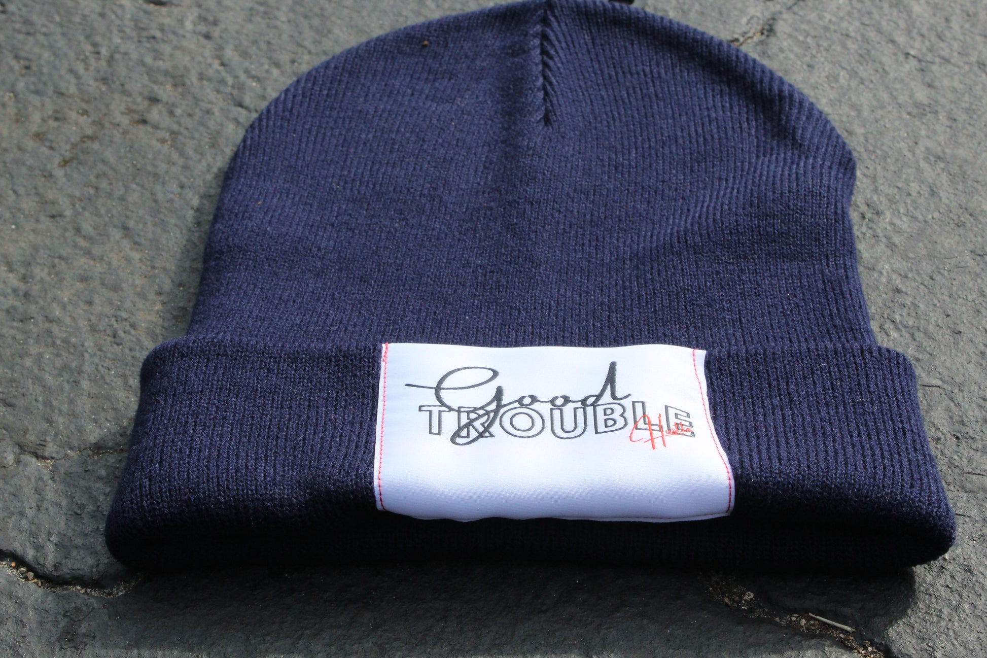Navy beanie with Good Trouble hustle Logo